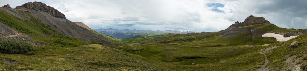 Fototapeta premium panorama of the tundra covered mountains with rain cloud skies
