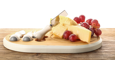Wooden board with pieces of tasty Parmesan cheese and grape on table against white background