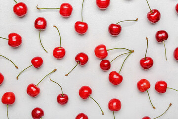 Obraz na płótnie Canvas Sweet cherries on light background