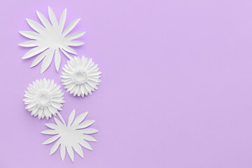 Composition with different origami flowers on color background