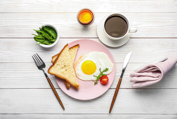 Composition with tasty breakfast and cup of coffee on light wooden background
