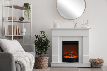 Fototapeta premium Interior of light living room with fireplace, shelving unit and mirror