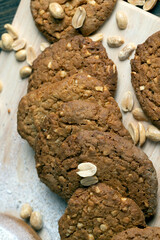 oatmeal cookies with peanuts on a black wooden table