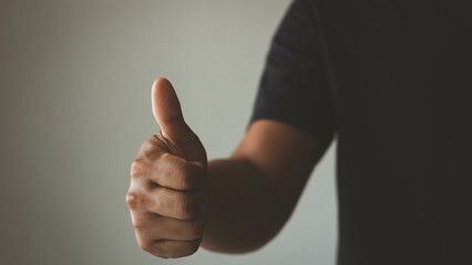 Man shows thumb up sign gesture. Businessman showing OK approve or like signal with thumb raise up. Successful concept.
