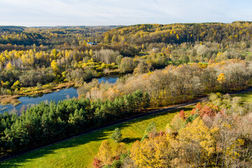 Aerial view of autumn forest with green and yellow trees. Beautiful fall scenery near Vilnius city, Lithuania