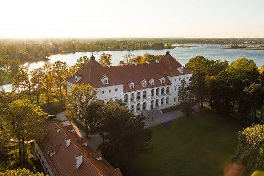 Beautiful aerial view of Birzai Castle surrounded by autumn vegetation on sunny fall day.