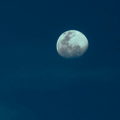 Naklejka na ściany i meble Image of the moon isolated over dark blue sky background.