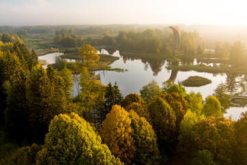 Amazing aerial view of Kirkilai karst lakes and lookout tower in the bright sunny autumn morning,...
