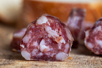 sausage sliced with a baguette on a wooden board
