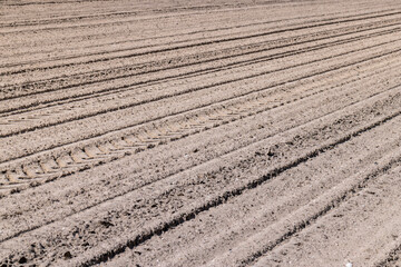 plowed soil in an agricultural field during tillage