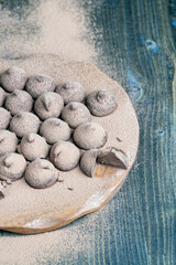 chocolate candies truffles on a wooden board