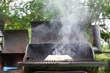 Grills made from liquid tanks, grills are burning smoke.