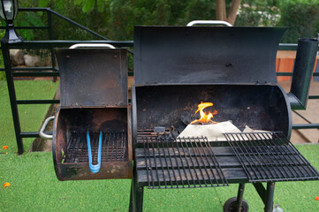Grills made from liquid tanks, grills are burning smoke.
