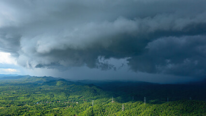 Aerial view rain storms and black clouds moving over the mountains In the north of Thailand, Pang Puai, Mae Moh, Lampang, Thailand. - obrazy, fototapety, plakaty