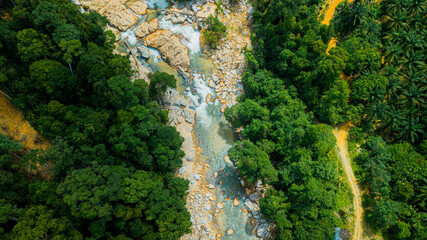 Aerial drone view of forest scenery with a river stream in Hutan Lipur Belukar Bukit, Kuala Berang, Terengganu, Malaysia.