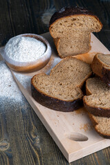 sliced rye bread on a wooden table, close up