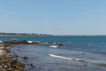 Rocks Along the Coastline with a Blue Sky