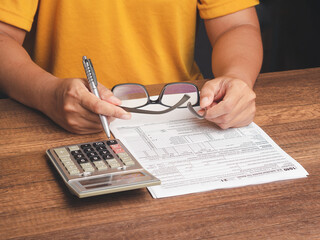 Tax day concept. Businessman using a tax form to complete individual income tax payment form