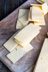 cut into pieces real hard cheese with lots of milk