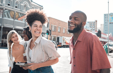 Happy, laughing group of friends walking and smiling together in a city. Casual excited people...