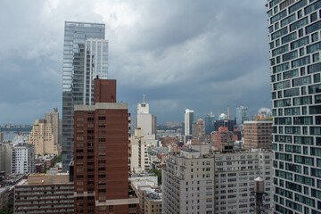 Fototapeta na wymiar Sunny daytime cityscape skyline view of skyscrapers on Manhattan Island in New York City, New York, USA