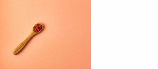 Bixa Orellana - Red organic achiote seeds in the spoon