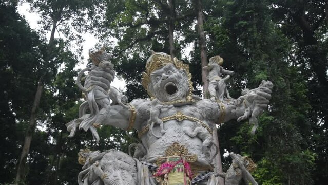 Ancient statue of scary-looking warrior Kumbhakarna Rakshasa fighting with monkeys.