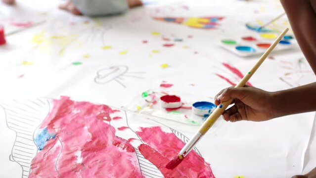 Creative art, drawing and painting being done by children, students or friends at school. Little, innovative and artistic kids doing a group task, project or assignment in a classroom together