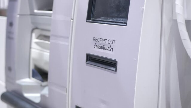 taking printed receipt from the cashier self machine kios when finish self payment in supermarket store