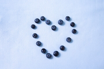 Blueberry heart on purple background