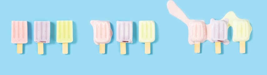 top view strawberries and blue berries and hami melon flavors popsicles melting process on a blue...
