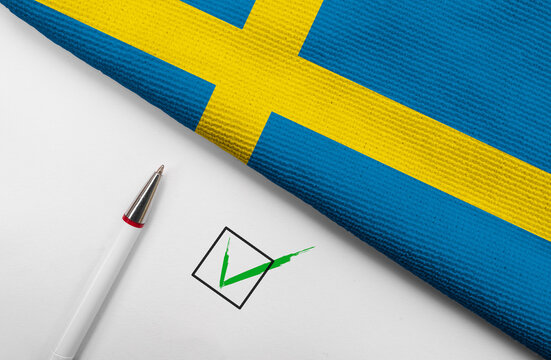 Pencil, Flag of Sweden and check mark on paper sheet
