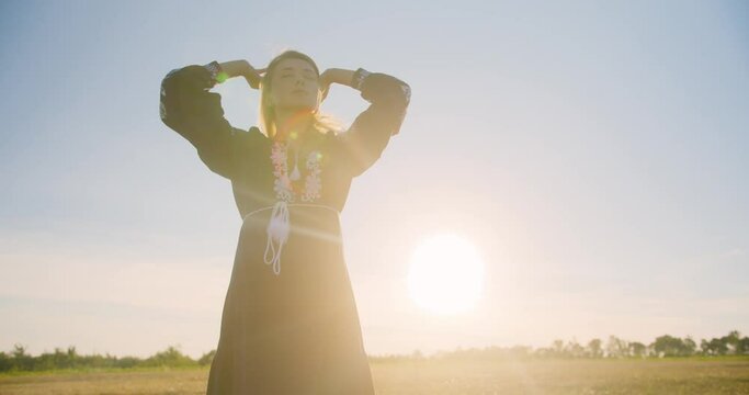 Portrait of young woman on a wheat field
A beautiful romantic village girl in an embroidered shirt in national ukrainian vyshyvanka shirt stands in a wheat field in sunset or sunrise rays of light