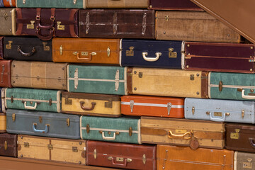 old and vintage suitcases under stairs 