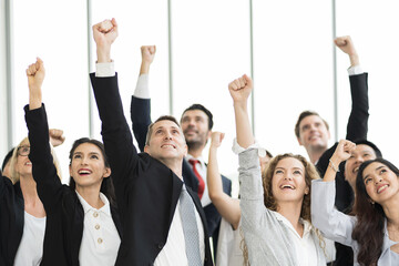 Group of diverse business people raised up hands cooperate for create power of team at business conference room