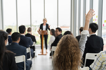Back view of business people raised up hand for question to speaker at business conference. Back view of diverse business people meeting at business conference room