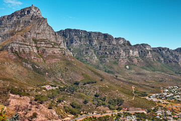 Fototapeta na wymiar Beautiful, relaxing and calming panoramic view of Table mountain in Cape Town, South Africa. Banner of lush green bushes and trees growing on rocky peaks with trails and scenic views of the city