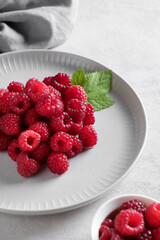 White plate with fresh rasberries. Top view food. 
