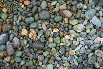 Pebble beach stones background, natural rounded gravel on the seashore