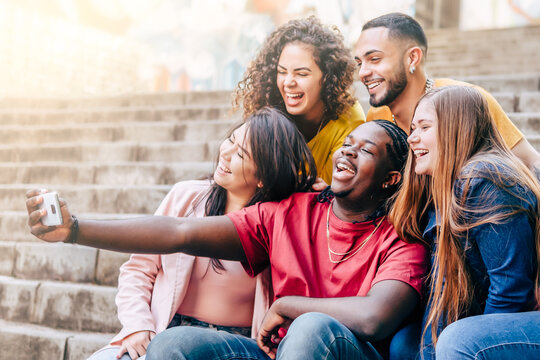Multiracial group of young hipster friends make selfie with smartphone - Happy life style concept with young students having fun together - Focus on Black Man