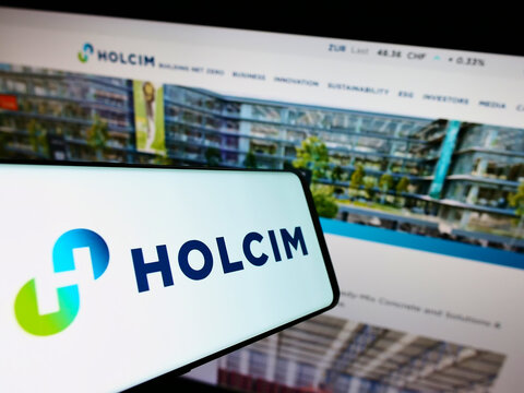 Stuttgart, Germany - 09-01-2022: Smartphone with logo of Swiss building materials company Holcim Limited on screen in front of website. Focus on center-right of phone display.