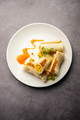 Indian paneer bread roll made using spiced grated cottage cheese mixed with spices & rolled & baked