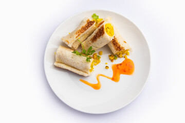 Indian paneer bread roll made using spiced grated cottage cheese mixed with spices & rolled & baked