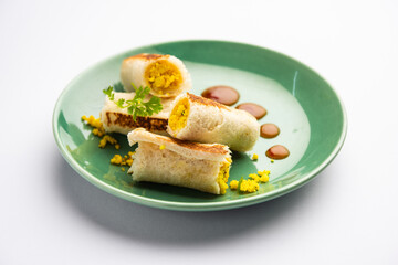 Indian paneer bread roll made using spiced grated cottage cheese mixed with spices & rolled & baked