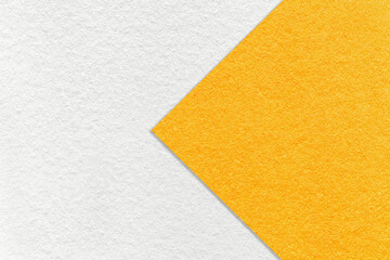Fototapeta premium Texture of white and bright yellow paper background, half two colors with arrow. Structure of craft orange cardboard.