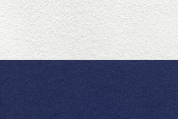 Texture of craft white and navy blue paper background, half two colors, macro. Structure of vintage...
