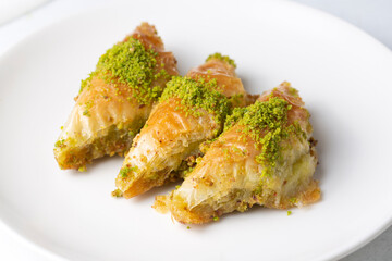 Turkish Dessert Sobiyet Baklava. Turkish pistachio baklava on a white background. Local name şöbiyet baklava
