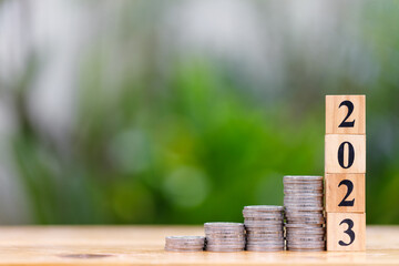 Money saving and investment concept for new year 2023 with coins stacking and copyspace