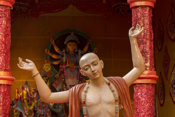 Beautifulidol of a Baisnav monk with backgroung Hindu goddess Durga idol in Kolkata.