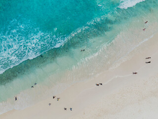 Aerial view of  sand beach with tourist people and  Beautiful sea waves in Summer tropical background